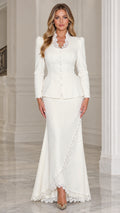 Front view of woman wearing white lace-trim peplum jacket and maxi skirt suit set