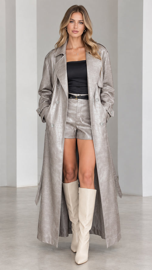 Full-length front view of model wearing metallic silver croc-embossed maxi trench coat