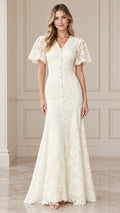 Front full view of woman wearing ivory floral lace V-neck mermaid maxi dress with flutter sleeves