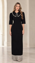 Front view of black pearl embellished collar maxi dress with fringe hem