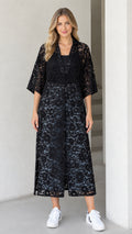 Front view of model wearing black floral lace midi duster dress with 3/4 sleeves