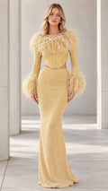 Front view of model wearing Champagne Gold feather-trim corset maxi dress