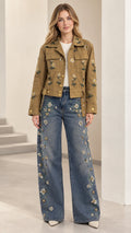 Front full view of camel floral embroidered utility jacket paired with wide-leg jeans