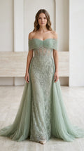 Front view of woman wearing sage green off-the-shoulder beaded tulle evening gown with train