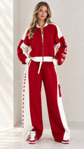 Full front view of model wearing women's red and white colorblock zip-up tracksuit set with wide leg pants