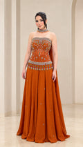Rust orange strapless evening gown with beaded embroidery and flowy skirt - front view