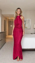 Front full-length view of model wearing magenta pleated draped halter maxi dress