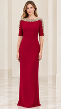 Front full-length view of model wearing burgundy embellished boat neck half sleeve evening gown