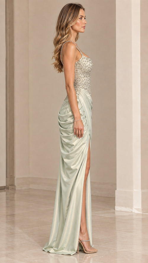 Side profile of model wearing sage green ruched satin maxi dress