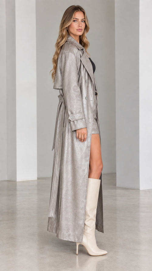 Side profile view of metallic silver croc-embossed long trench coat with belt