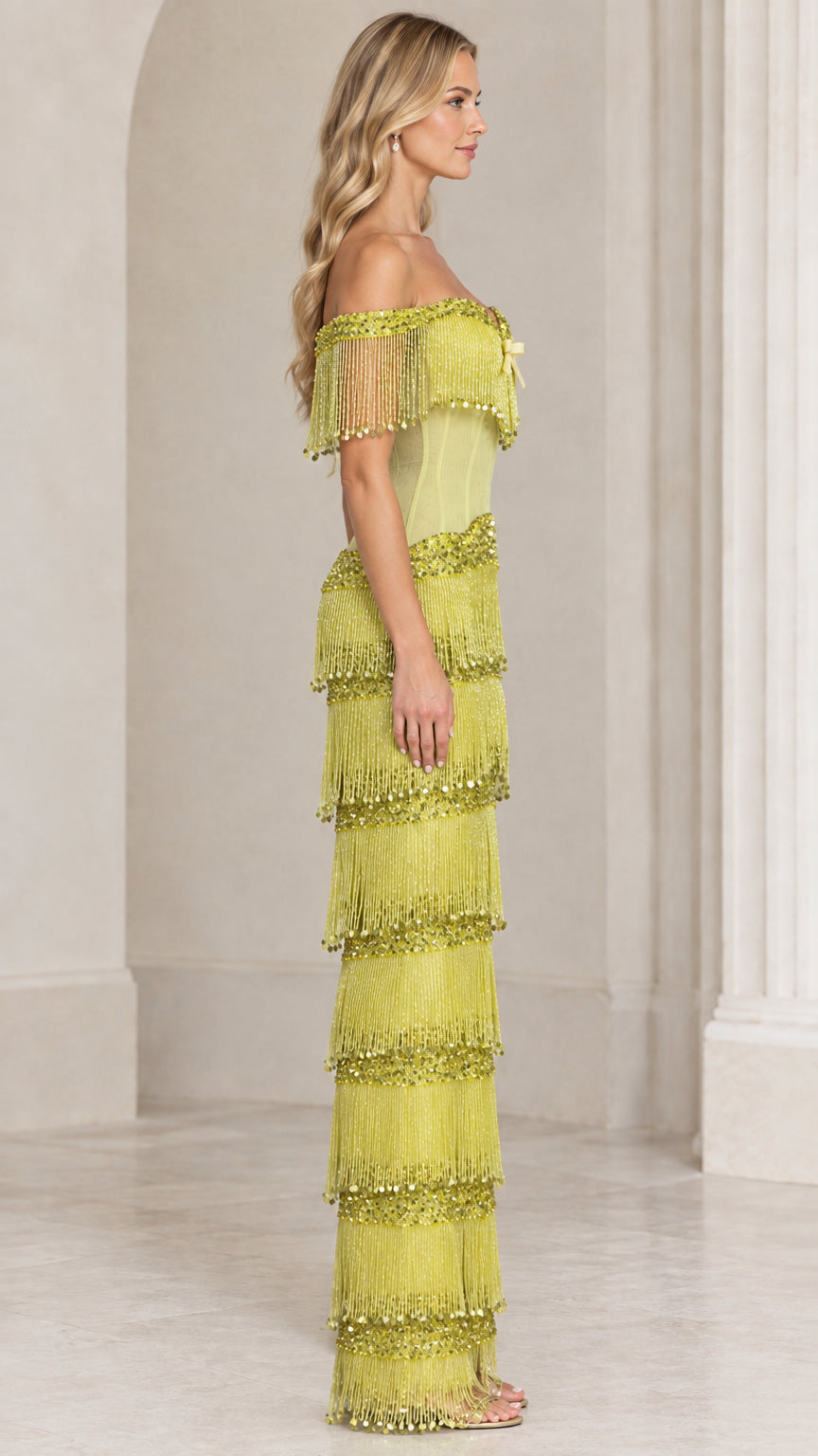 Side profile view of chartreuse tiered fringe corset evening gown
