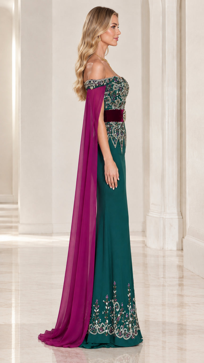 Side view of emerald green embellished formal gown with long flowing cape sleeves