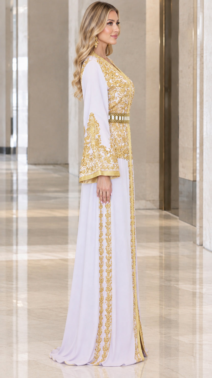Side profile view of woman modeling white embroidered kaftan evening dress