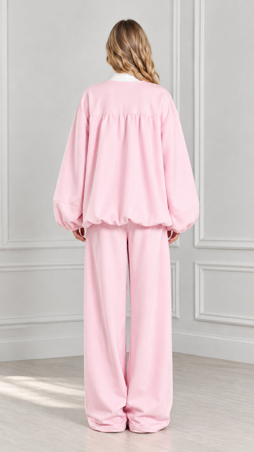 Back view of light pink gathered zip-up jacket and matching wide-leg trousers