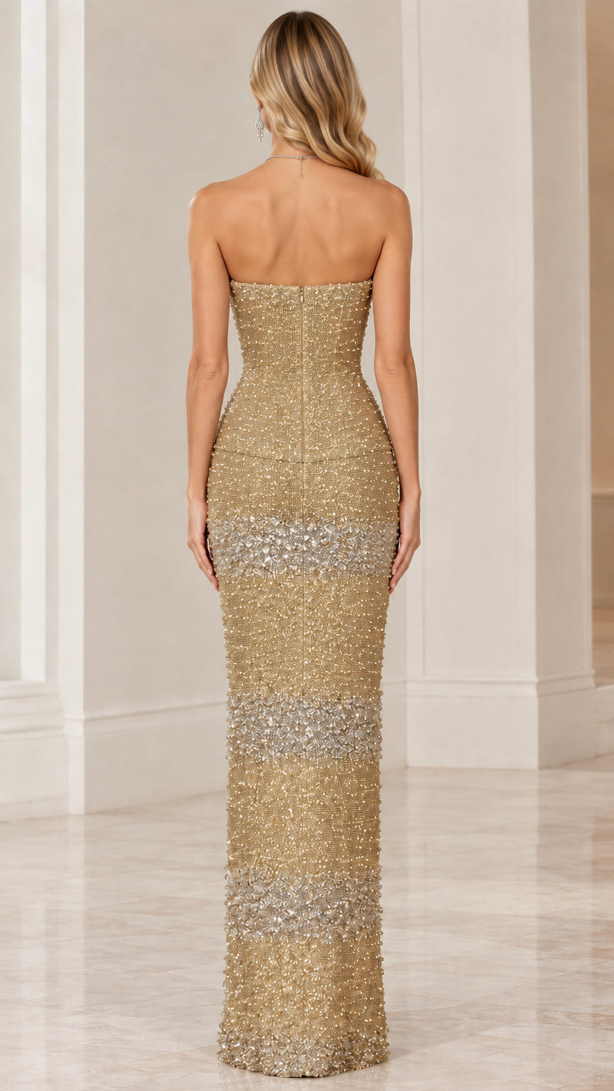 Back view of model in gold strapless beaded evening gown with concealed zipper