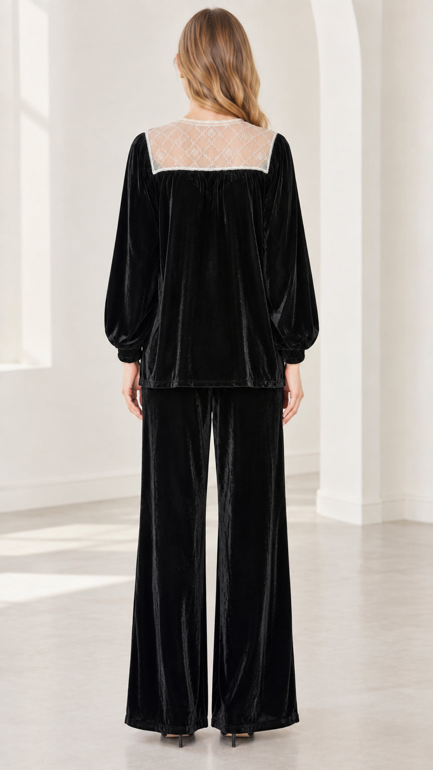 Back view of model showing black sheer lace back yoke on velvet long sleeve top