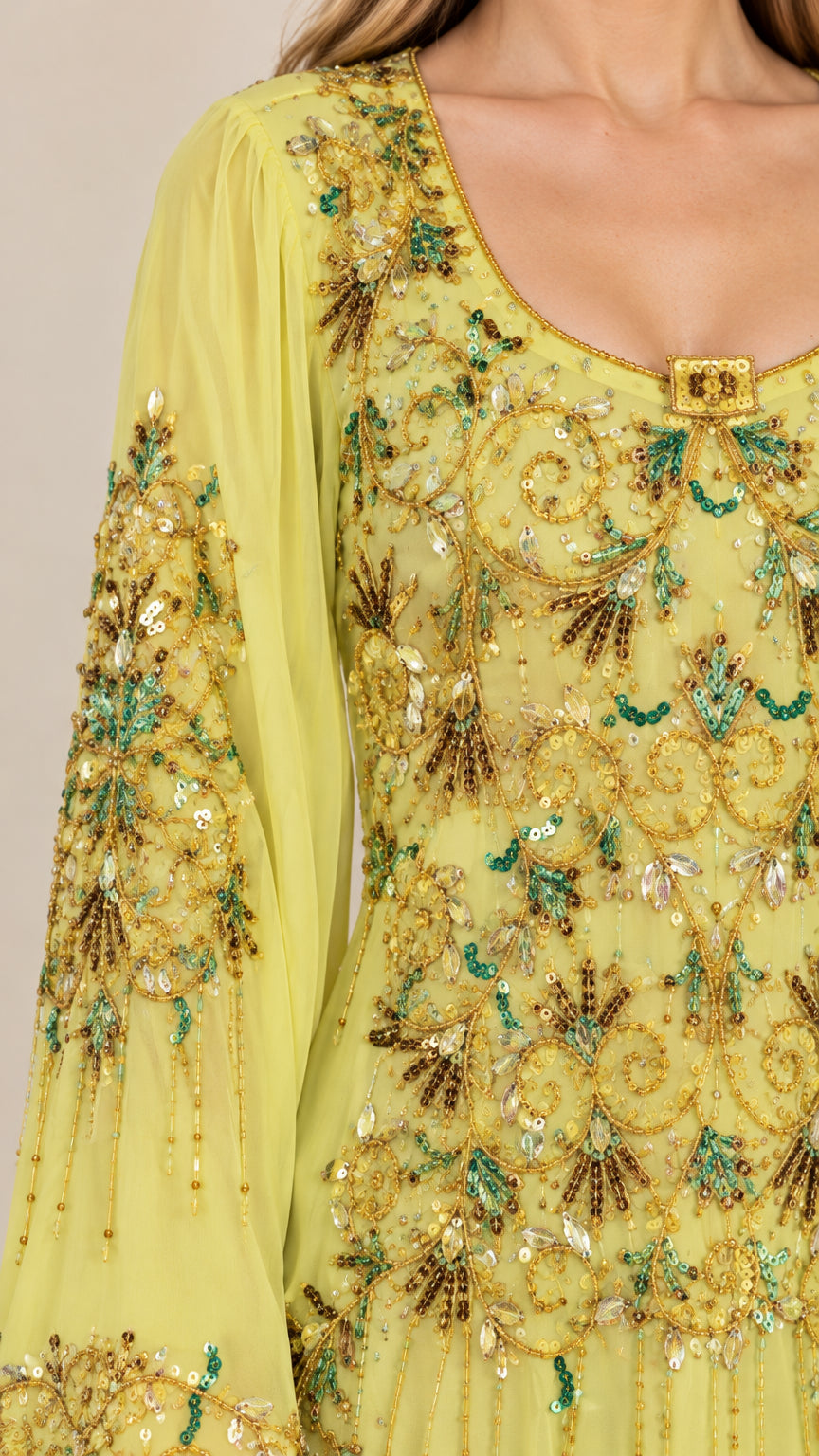 Close-up detail of scoop neckline and ornate sequin beadwork on yellow dress