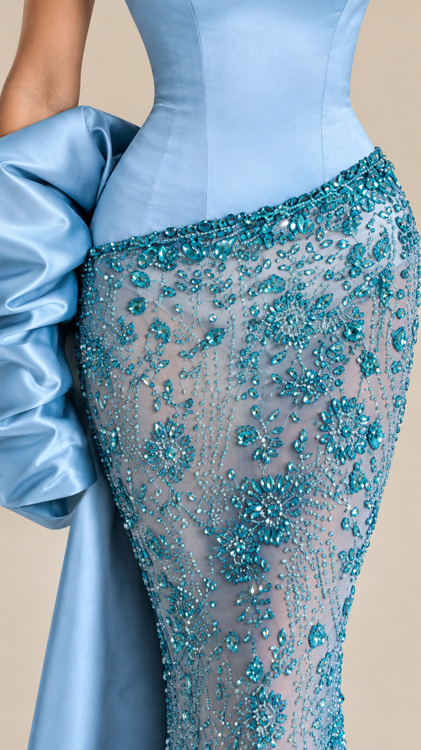 Close-up detail of satin corset waist and intricate crystal beading on sky blue gown