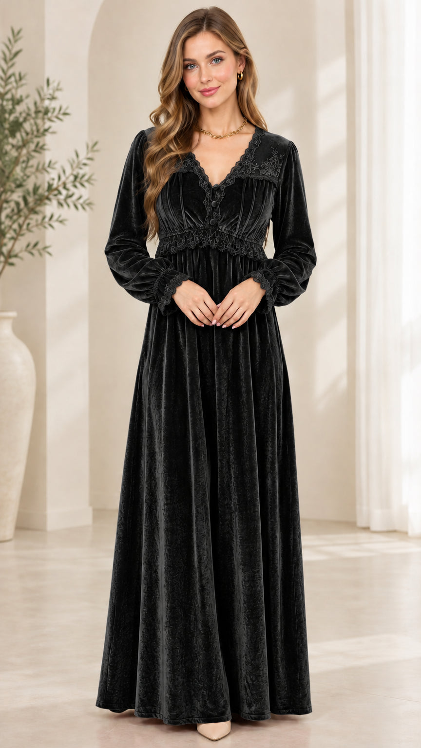Front view of model wearing black velvet long sleeve maxi dress