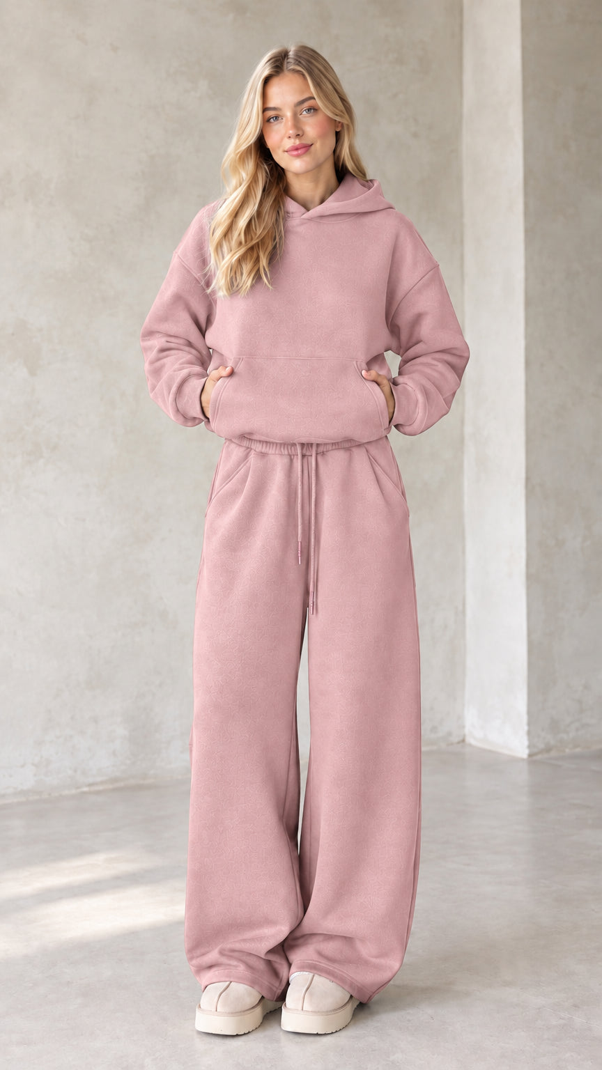 Front view of woman wearing dusty pink oversized hoodie and wide leg lounge set