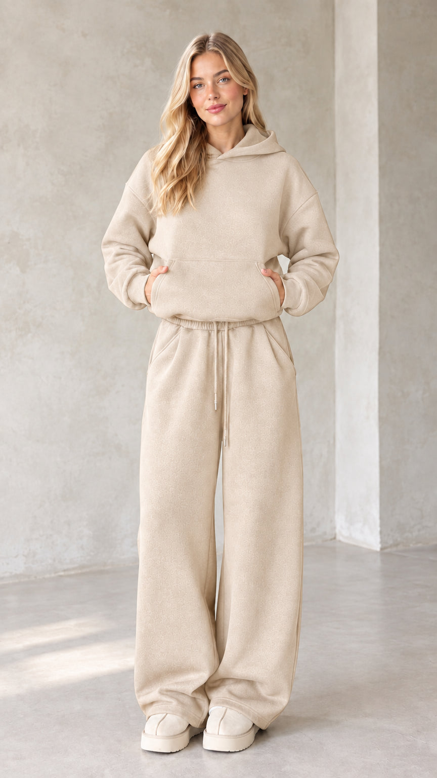 Front view of woman wearing beige oatmeal oversized hoodie and wide leg lounge set