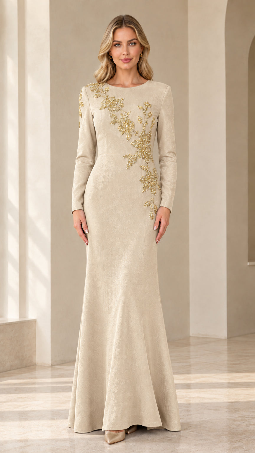 Model wearing champagne cream long sleeve evening gown with gold embroidery